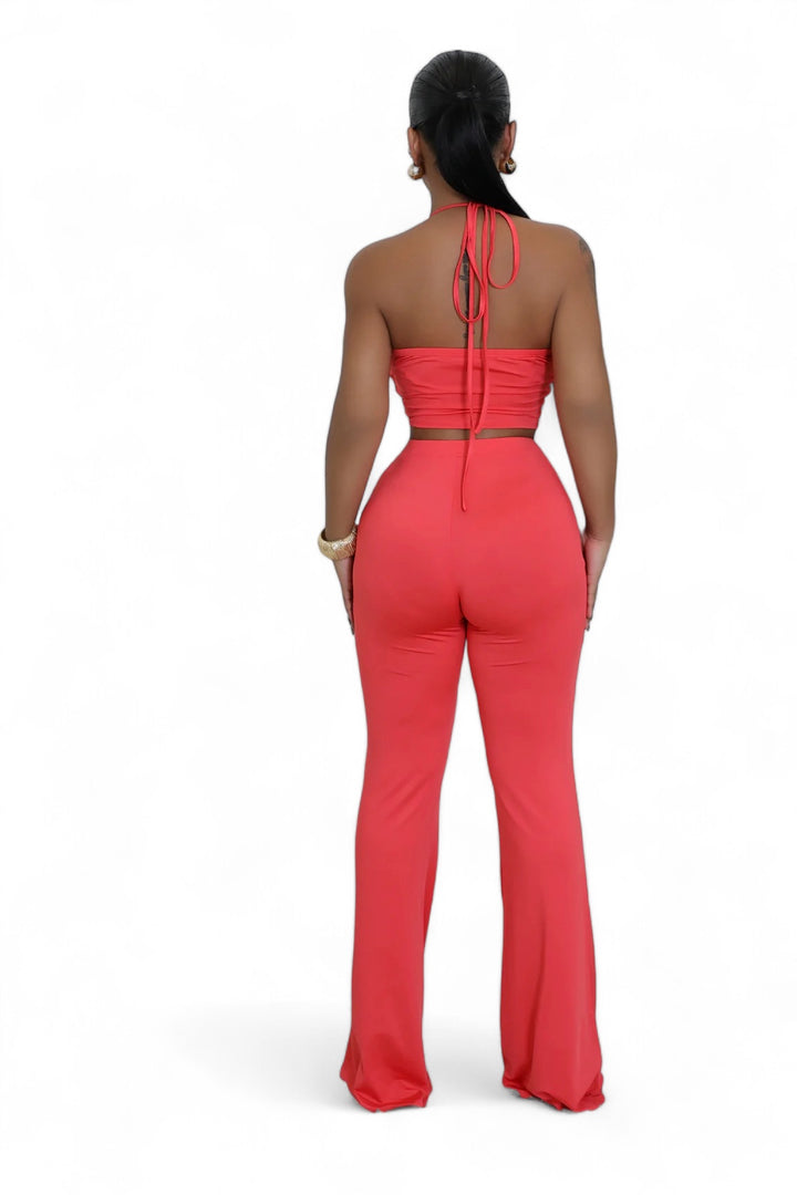 the back of a woman in a red jumpsuit