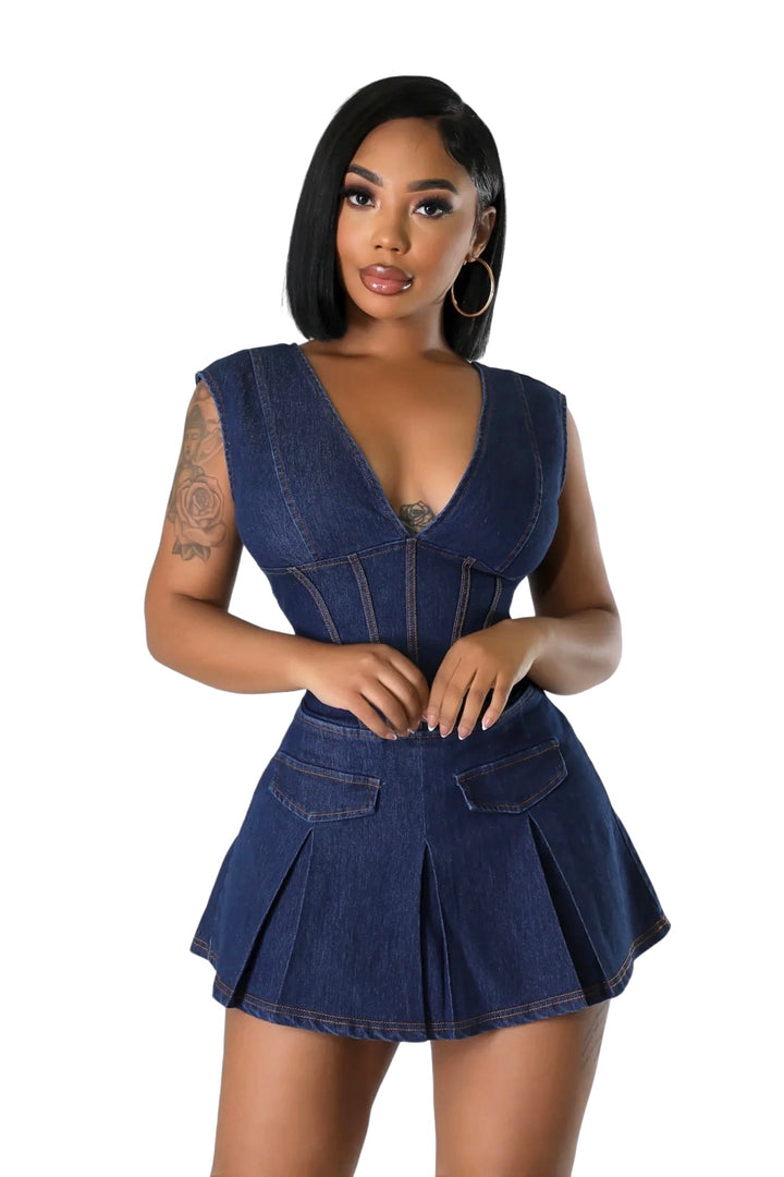 a woman in a short denim dress posing for a picture