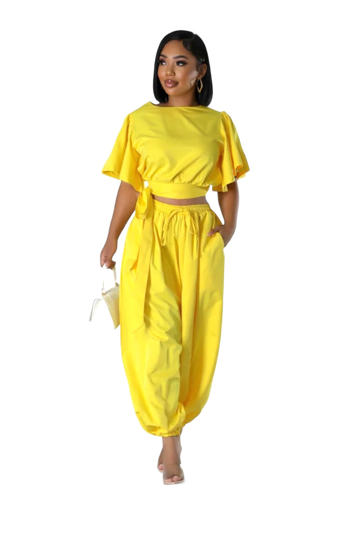 a woman in a yellow top and pants