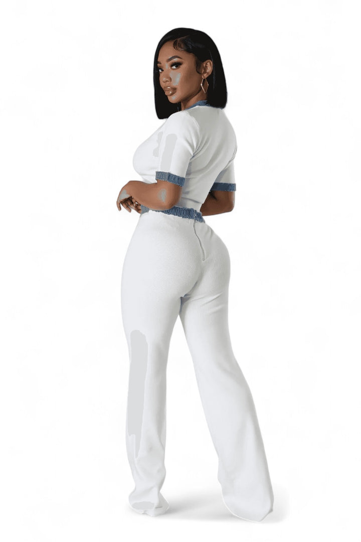 a woman in a white jumpsuit posing for a picture