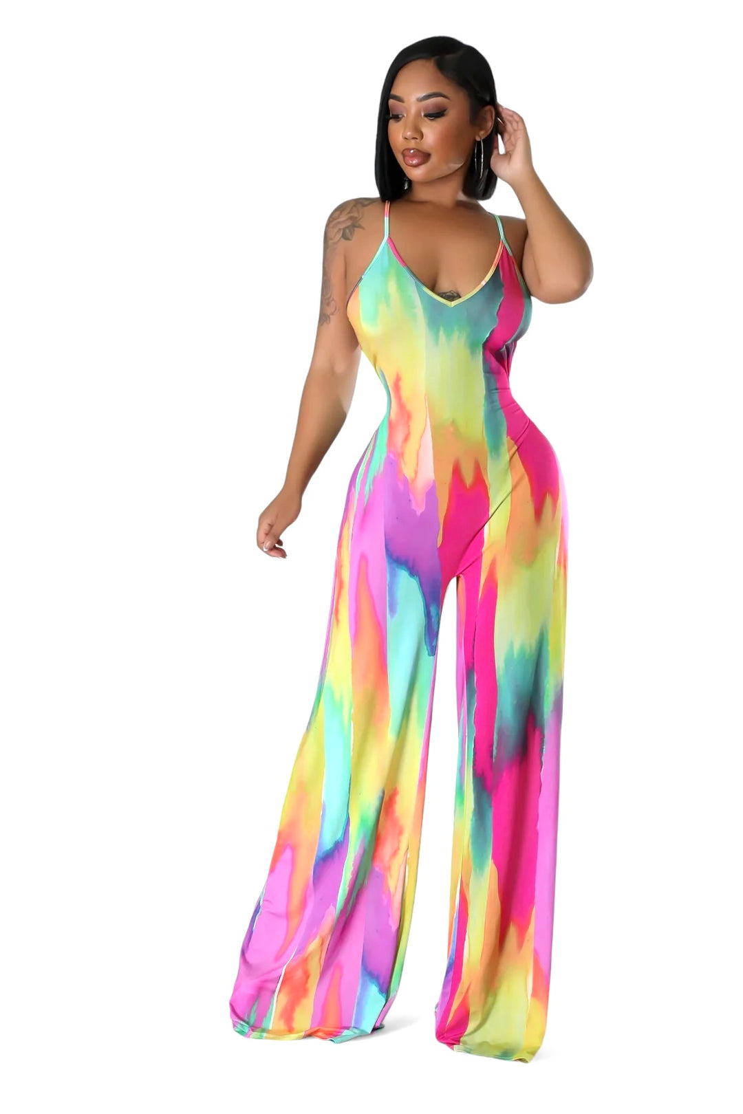 a woman wearing a colorful tie dye jumpsuit