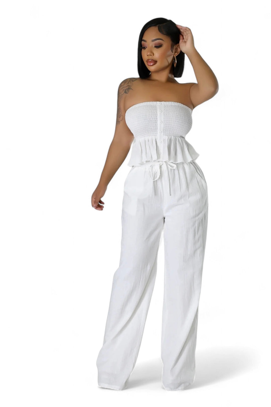 a woman in a  white strapless top and wide legged pants