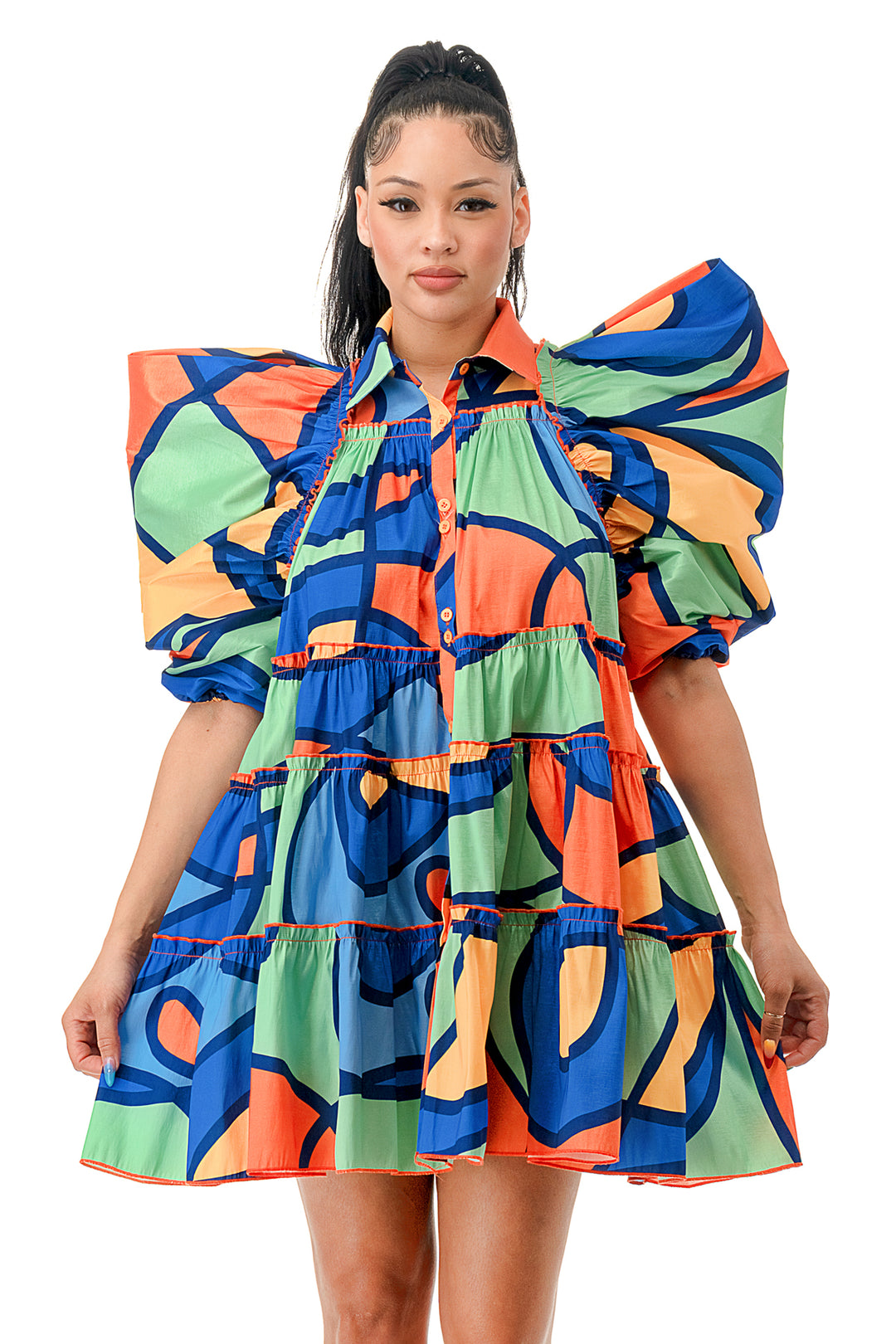 a woman is wearing a colorful dress with a frilled neckline