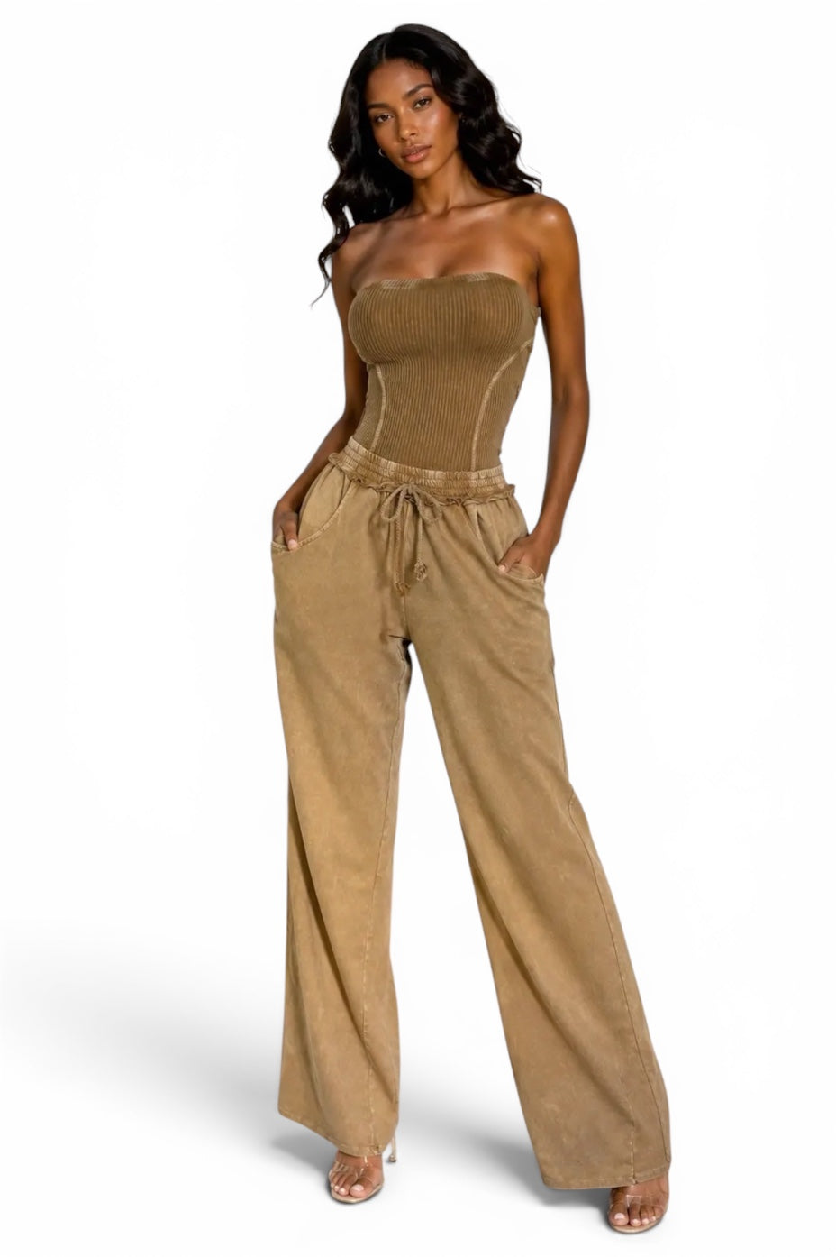 Tan acid-wash strapless jumpsuit for women featuring a fitted corset-style bodice, wide-leg pants, drawstring waist, and side pockets.