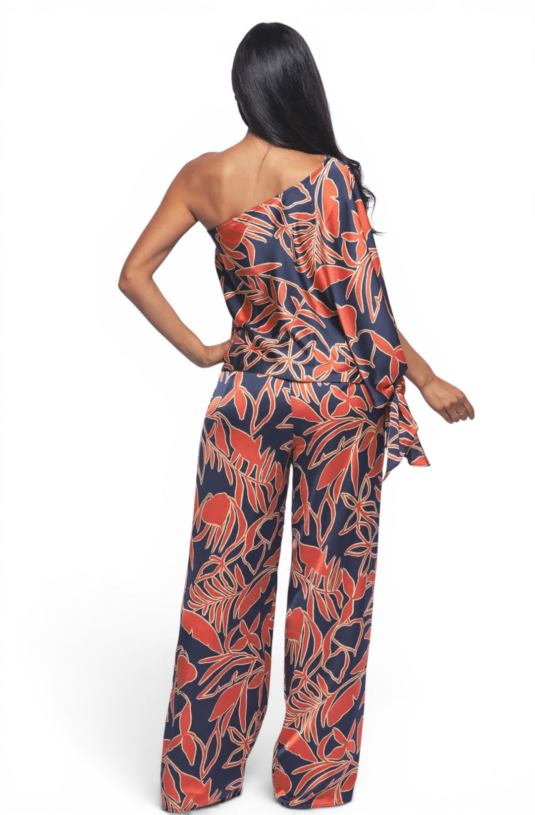 Back view of a tropical satin one-shoulder matching set featuring wide leg pants and an elegant botanical print design.