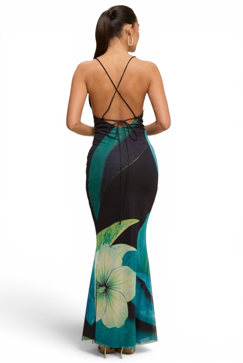 Woman wearing a tropical floral print mermaid maxi dress with a cowl neckline, adjustable spaghetti straps and lace-up open back.