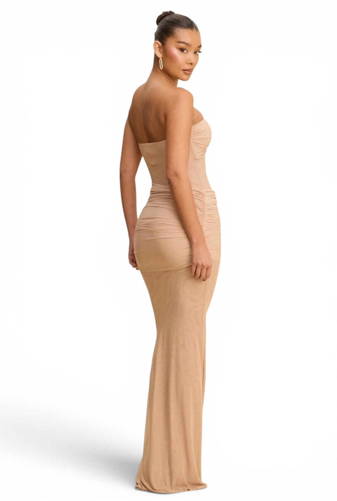 Woman wearing a tropical floral print mermaid maxi dress with a cowl neckline, adjustable spaghetti straps and lace-up open back.
