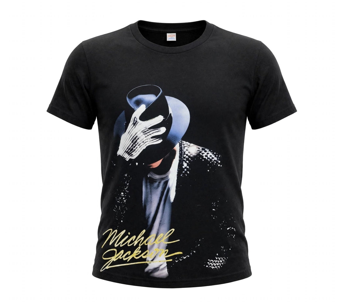 A black short-sleeve t-shirt featuring a graphic print of Michael Jackson in a black suit and mask with a white glove, and his name in yellow script on the front, set against a plain white background.