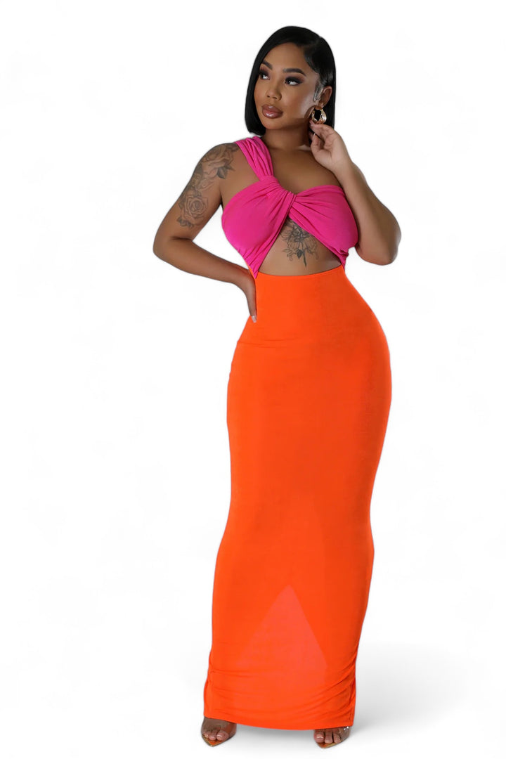 a woman in an orange skirt talking on a cell phone