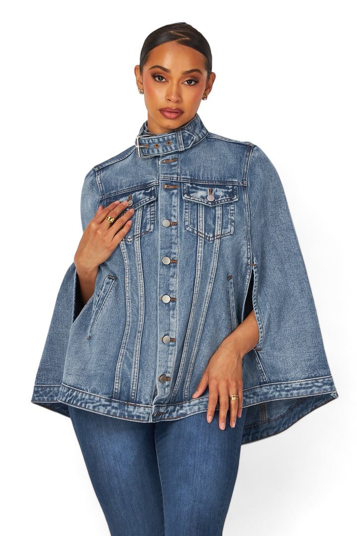 a woman wearing a denim jacket and jeans