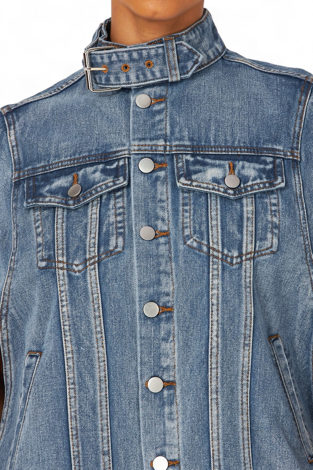 a woman wearing a jean jacket with buttons