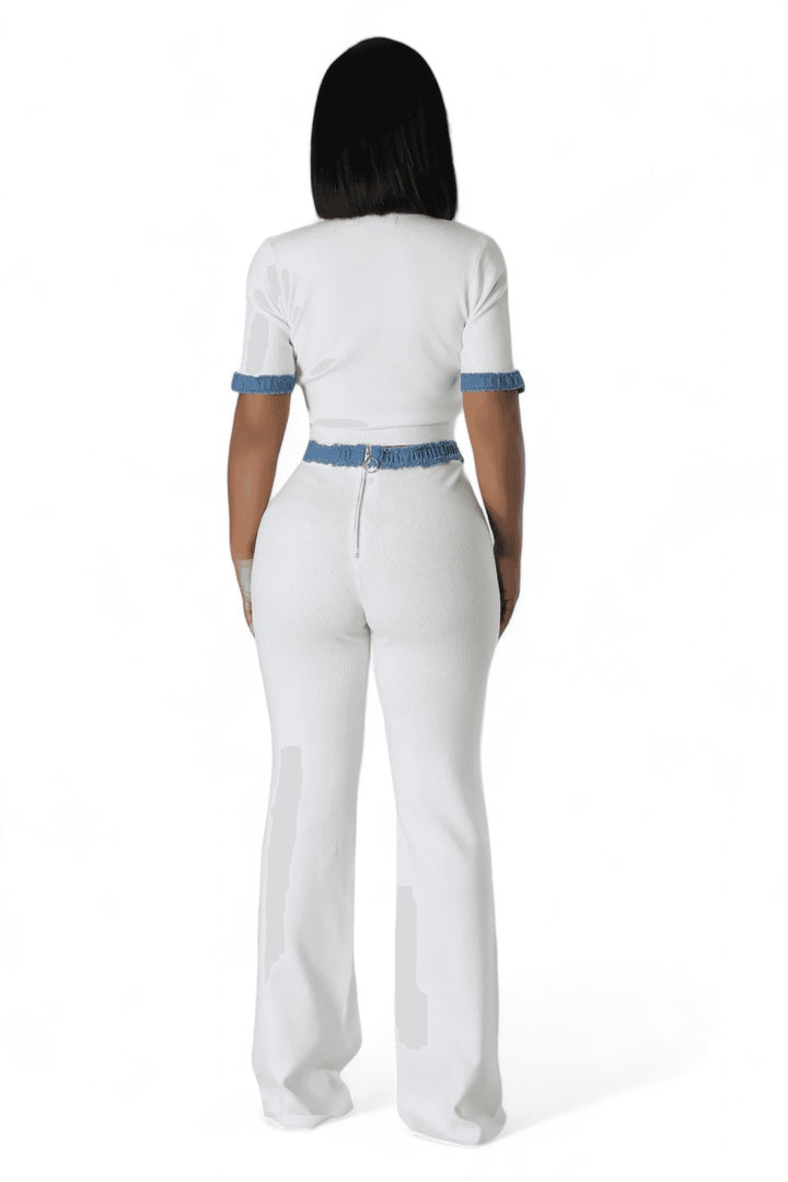 a woman in a white jumpsuit with a blue belt