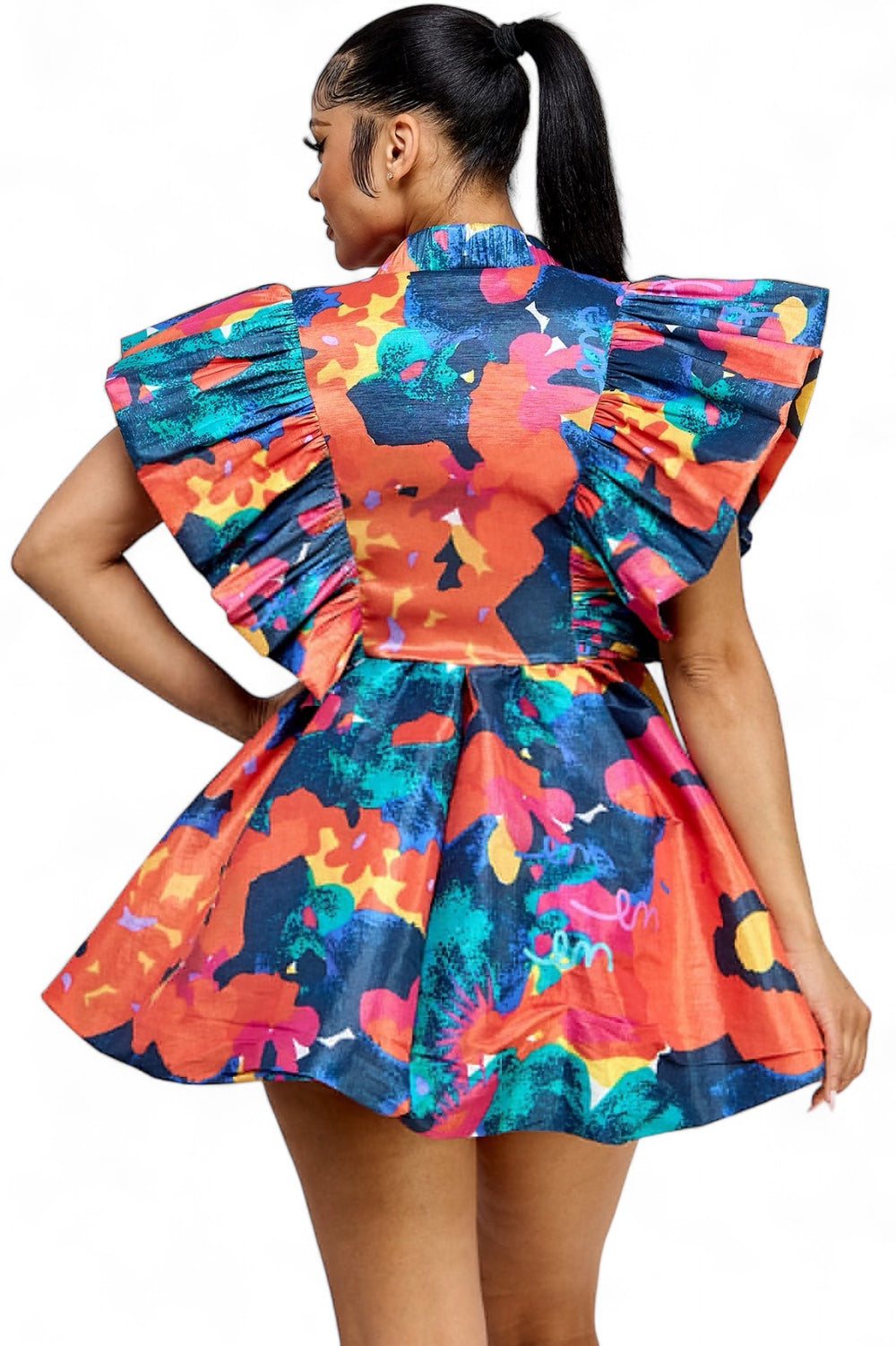 a woman in a colorful dress with a ponytail
