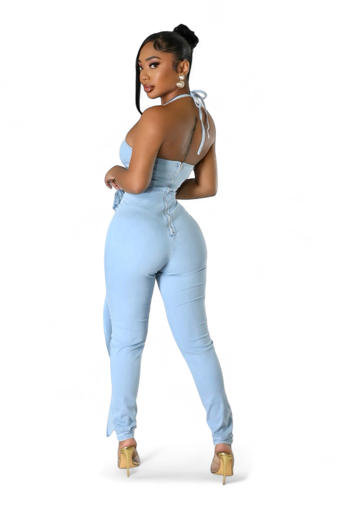 a woman wearing a blue jumpsuit and heels