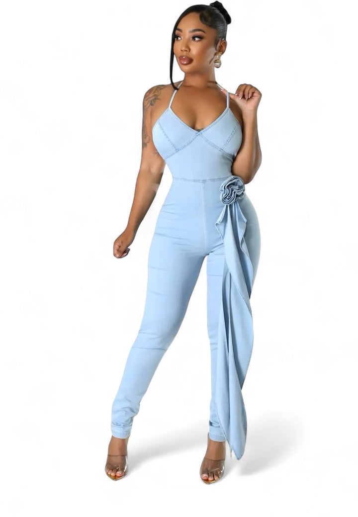 a woman in a blue jumpsuit posing for the camera