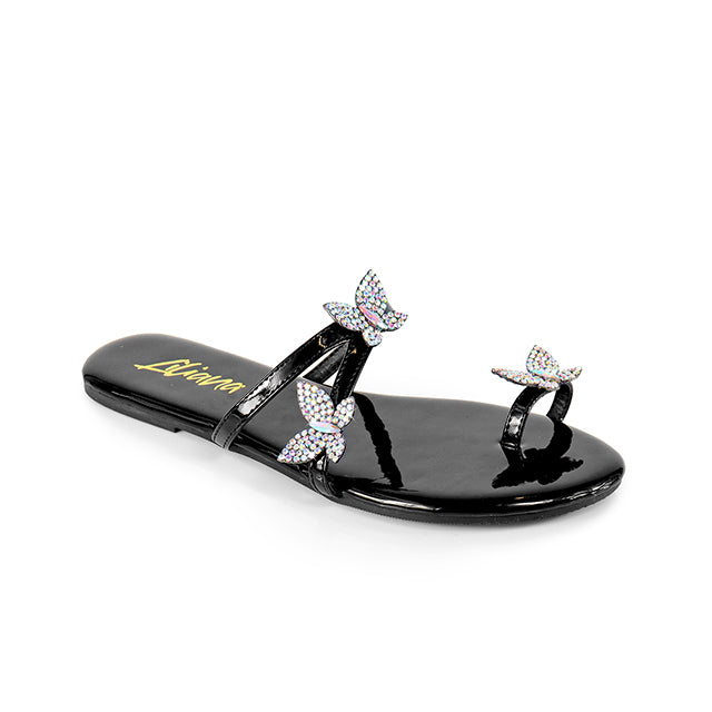 a pair of black sandals with bows on them