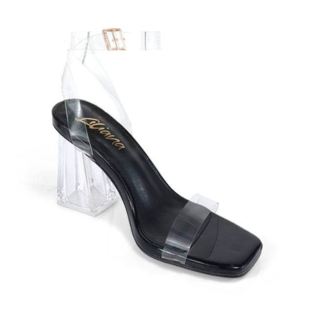 a pair of black high heels with clear heels