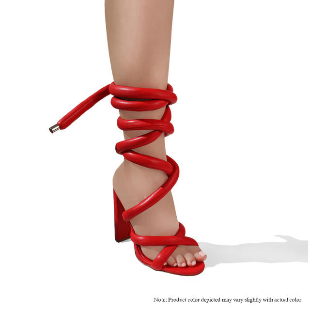 a woman's red high heeled sandal with a tie
