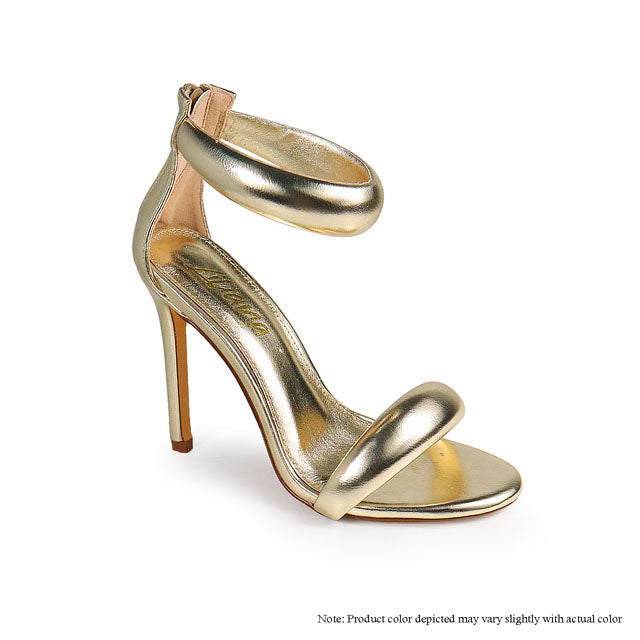 a pair of gold high heeled shoes on a white background