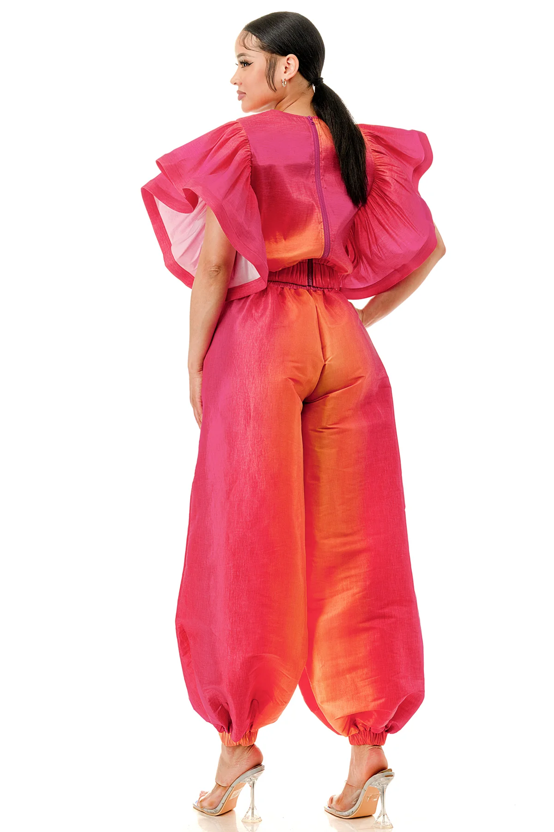 a woman in a pink and orange jumpsuit