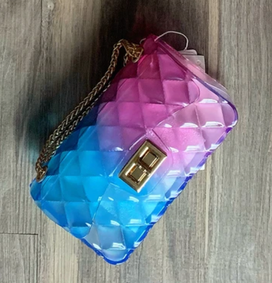 a colorful handbag sitting on top of a wooden floor