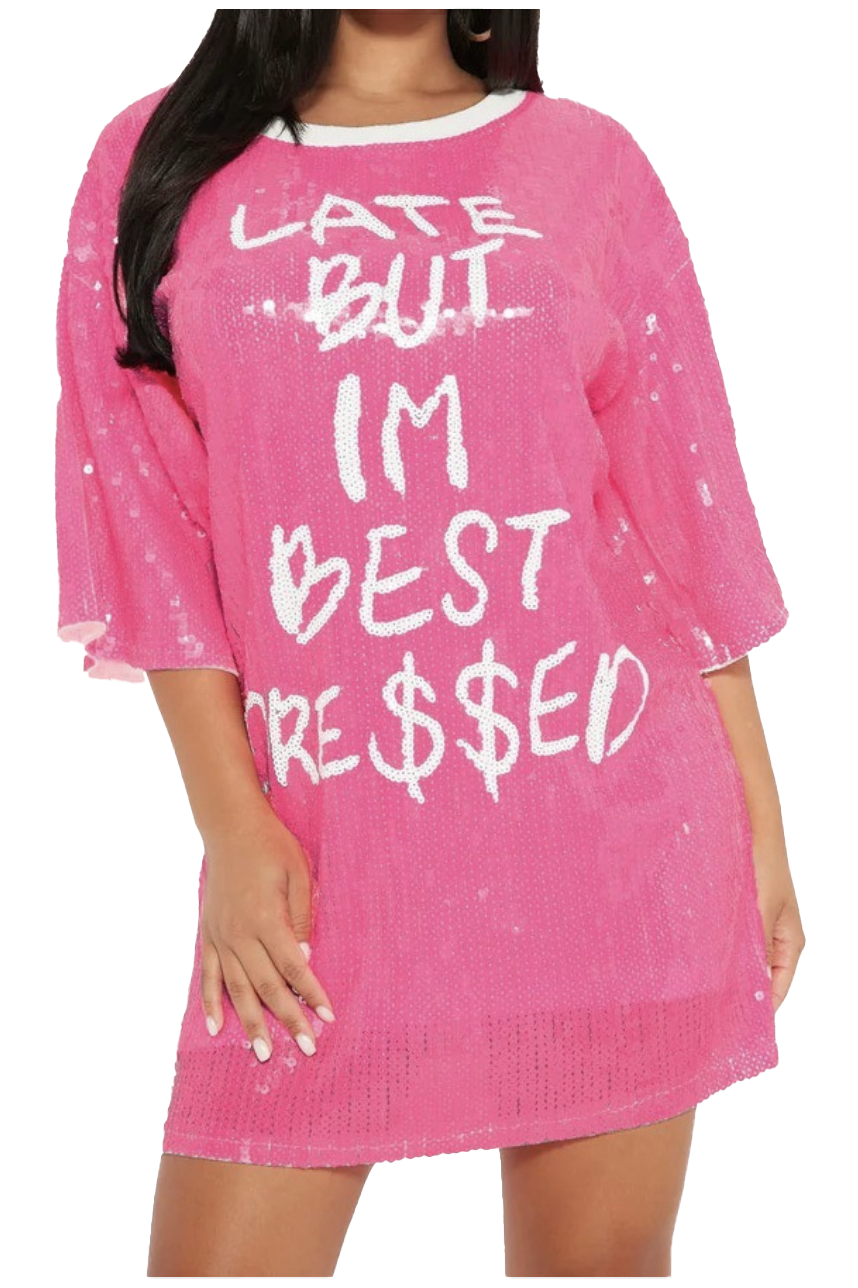 a woman wearing a pink sweater with white writing on it