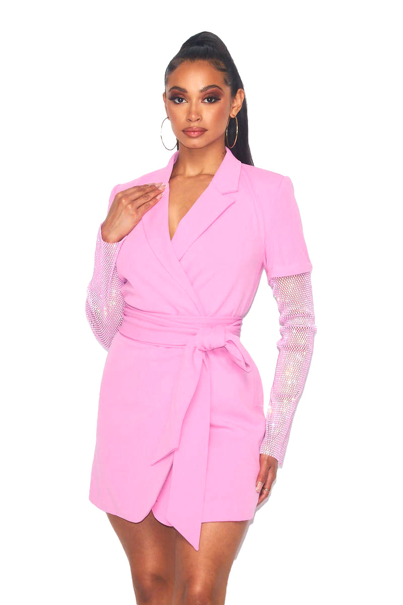 a woman wearing a pink dress with sheer sleeves