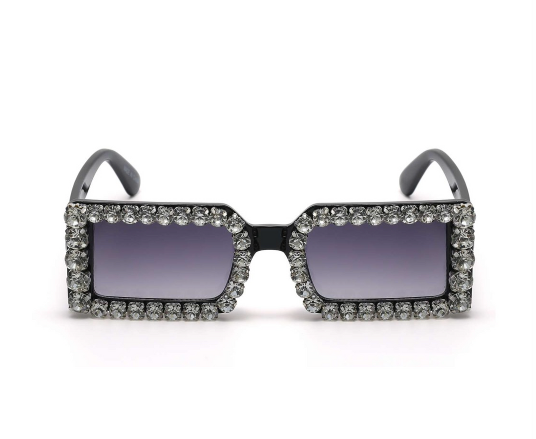a pair of sunglasses with crystals on the sides