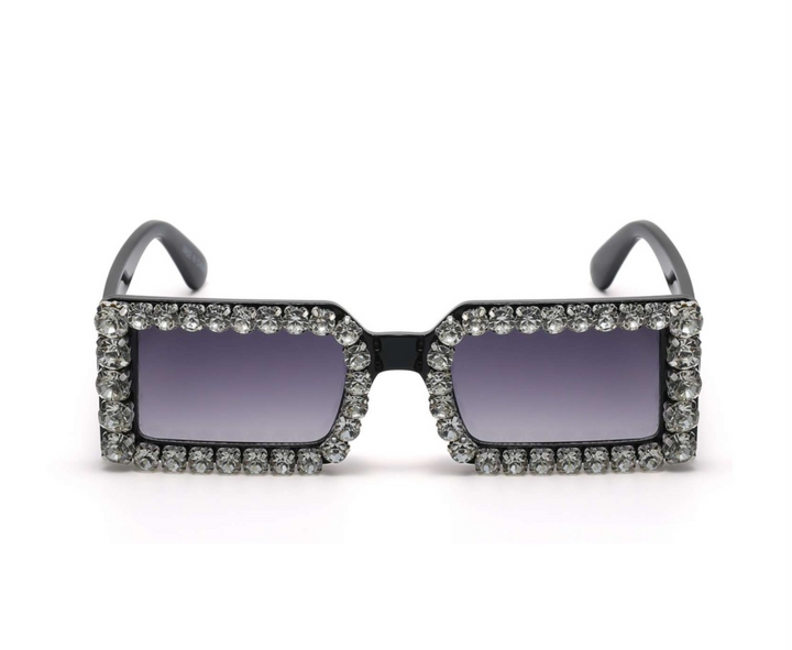 a pair of sunglasses with crystals on the sides
