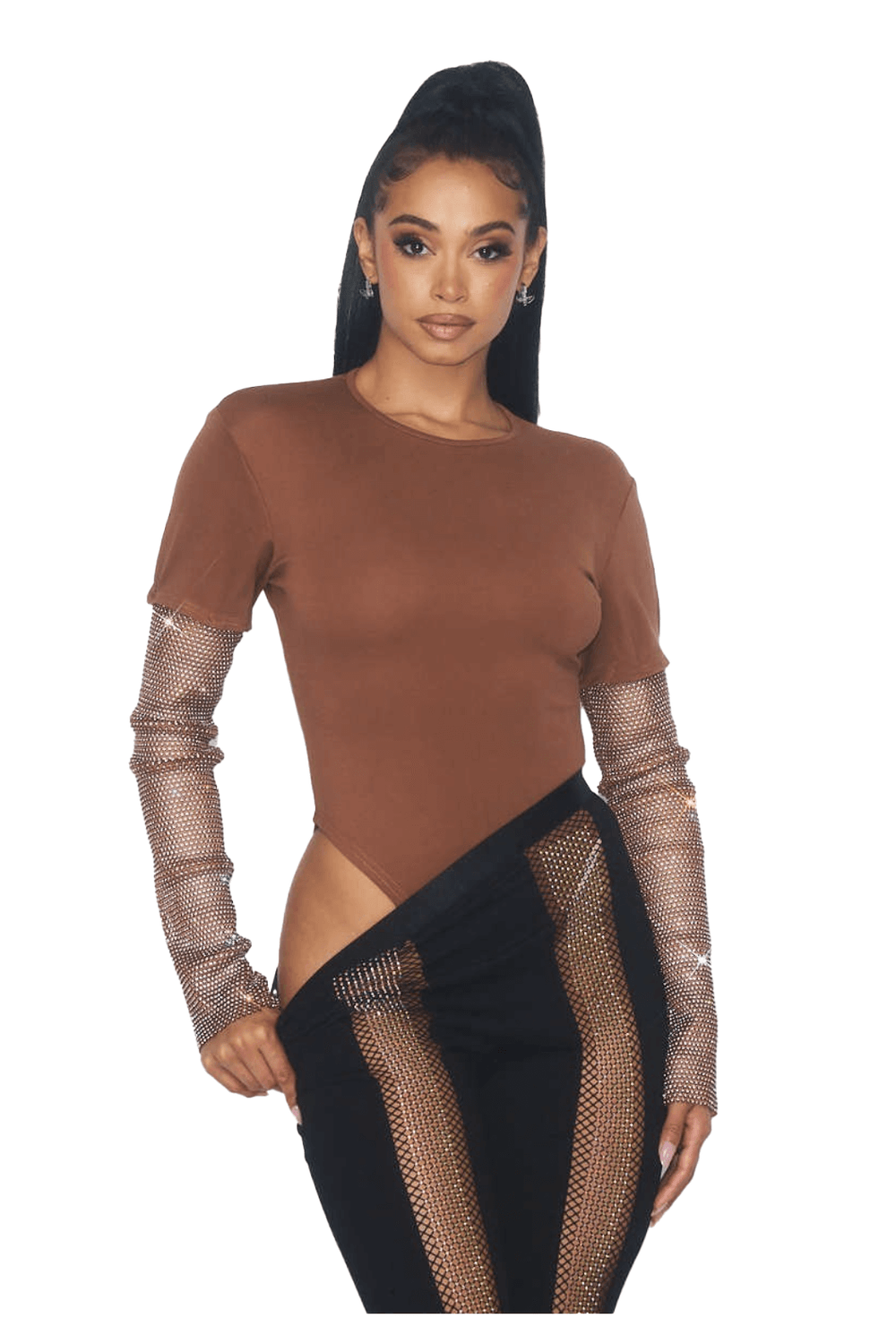 a woman wearing a brown top and black pants