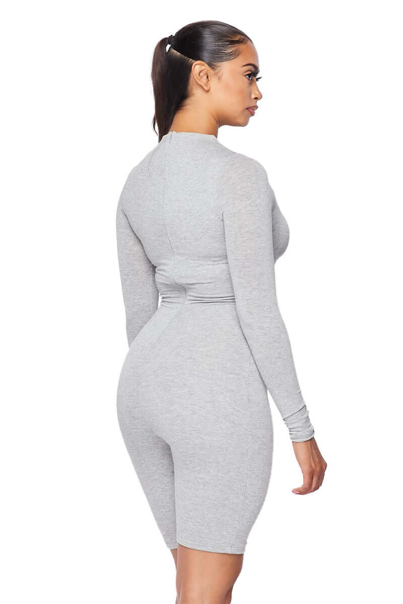 a woman in a grey bodysuit