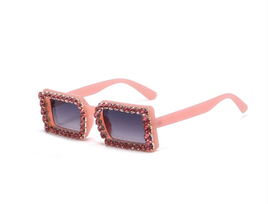 a pair of sunglasses with pink frames and crystals
